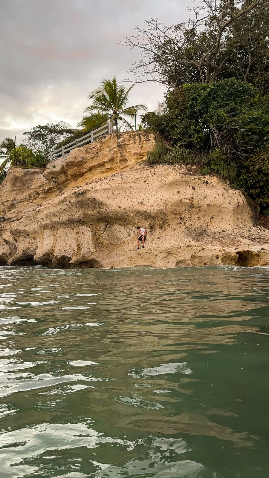Limestone cliff descending to turquoise water